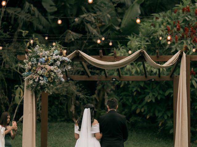 Outdoor wedding ceremony with floral arch